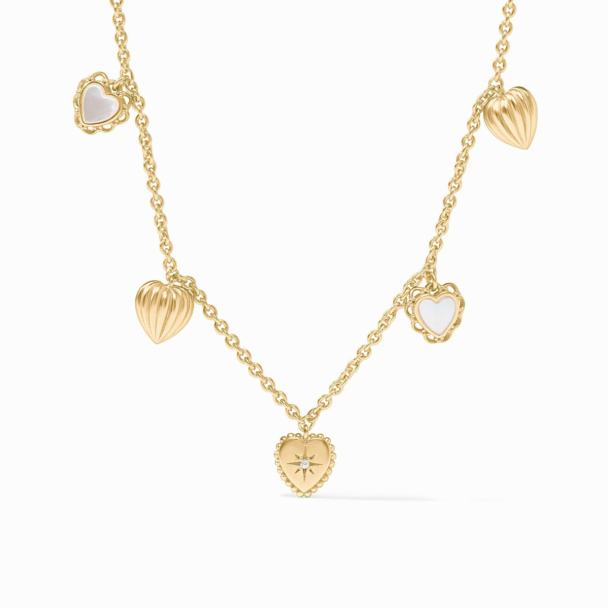 Gold chain necklace with five heart charms featuring mother of pearl, ridges, and a CZ starburst.