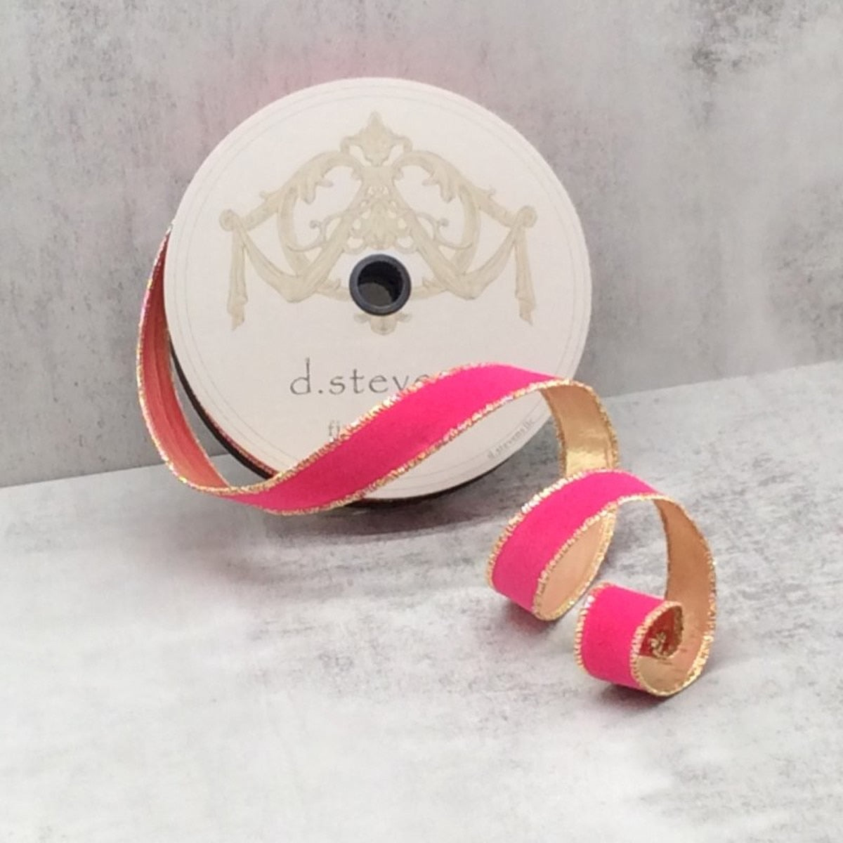 Hot pink flocked velvet ribbon with metallic gold edges on a d.stevens spool.