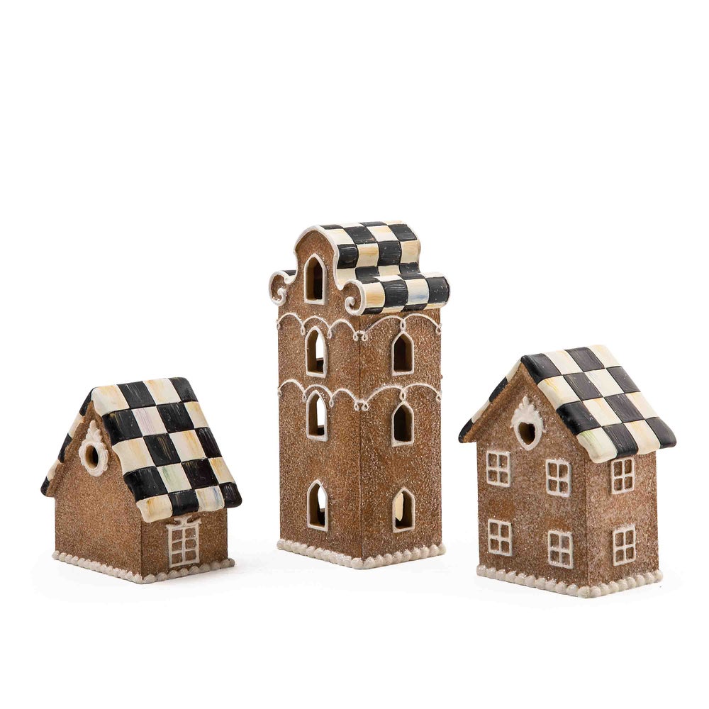 Illuminated gingerbread house made of resin with warm interior lighting.