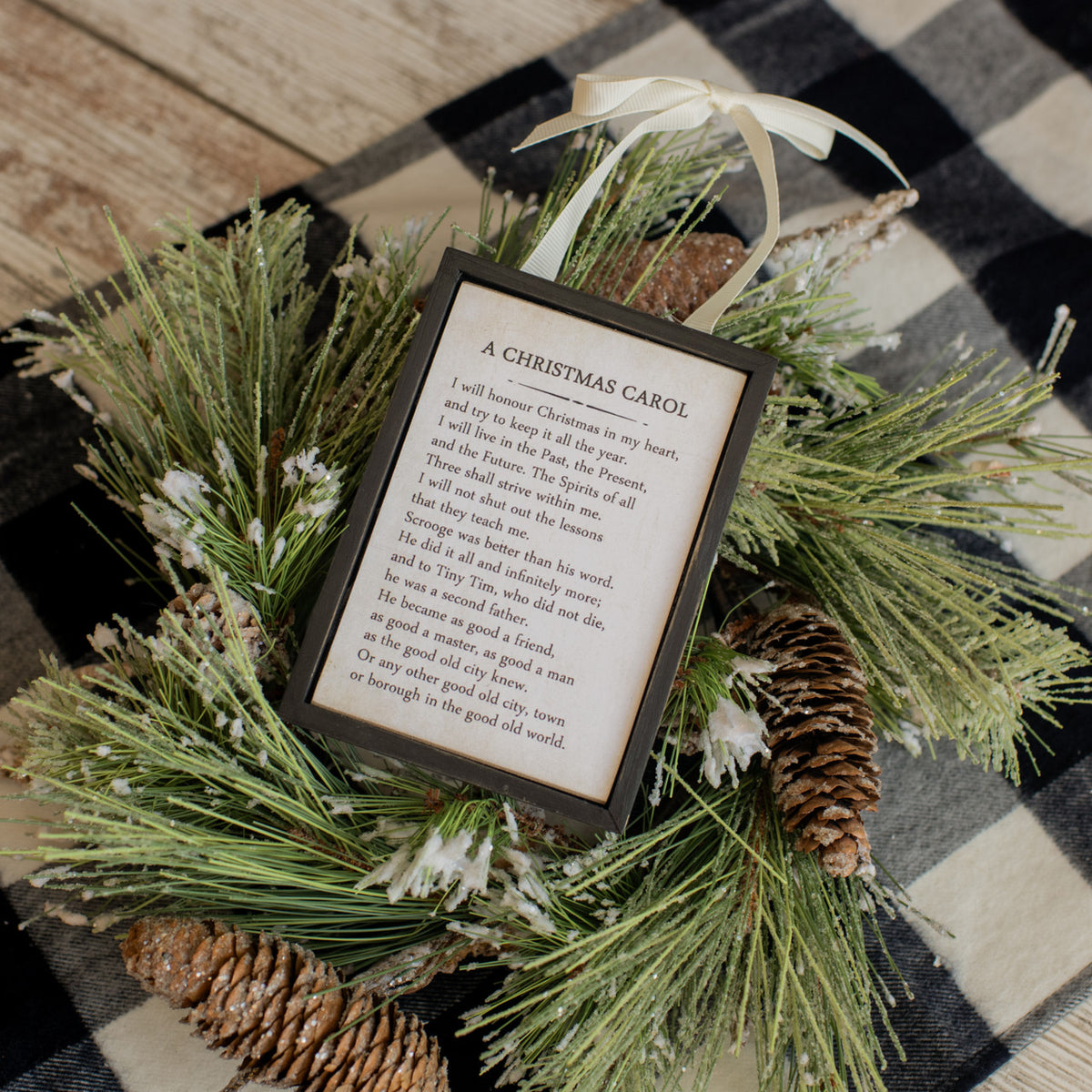 Wooden sign ornament shaped like a lowercase 'x' with natural grain texture.