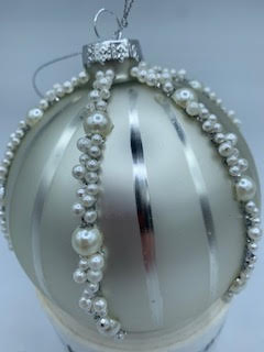 4-inch glass ball ornament in cream with vertical silver stripes and pearl bead accents.