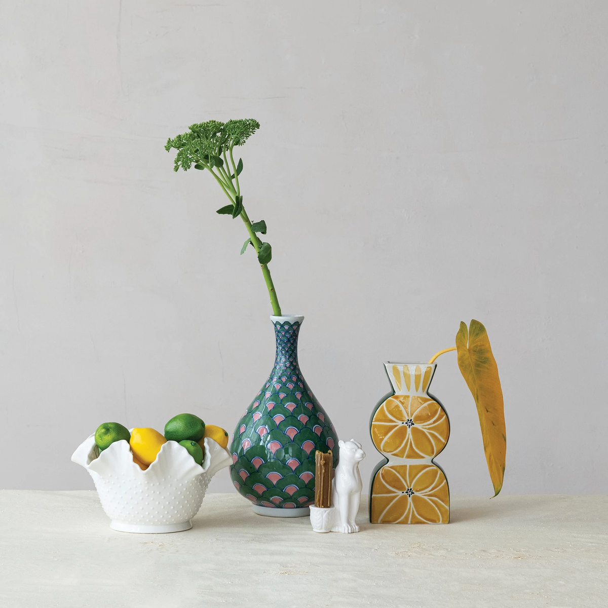 Round green stoneware vase with pink and blue hand-painted pattern