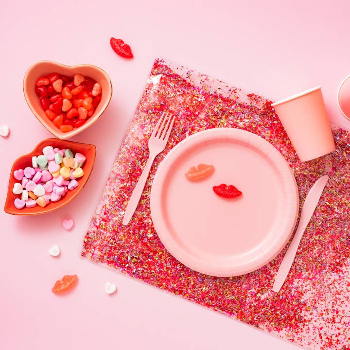 Clear plastic desk pad with pink, red, gold, and iridescent confetti pattern