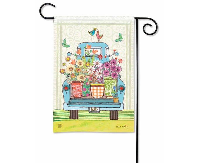 Blue vintage truck filled with colorful flowers, two birds on top, on a garden flag.
