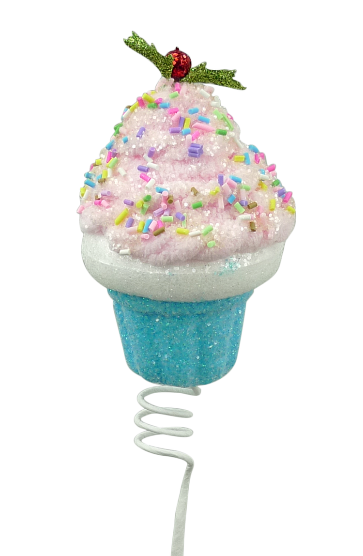 Glitter chenille cupcake pick with pink frosting, sprinkles, and a holly topper on a white spring.