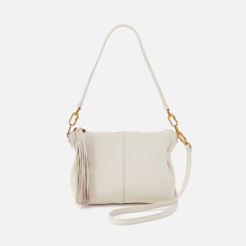 Kori crossbody bag in sandlewood with brass hardware featuring zip pocket back and slip pen pockets front.