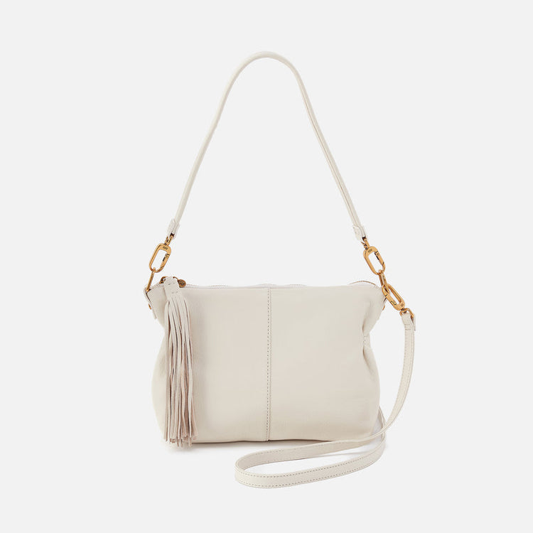 Kori crossbody bag in sandlewood with brass hardware featuring zip pocket back and slip pen pockets front.