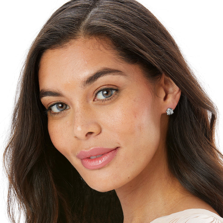 A woman wearing the Lady Luck Mini Post Earrings, which are silver-plated ladybug-shaped studs.