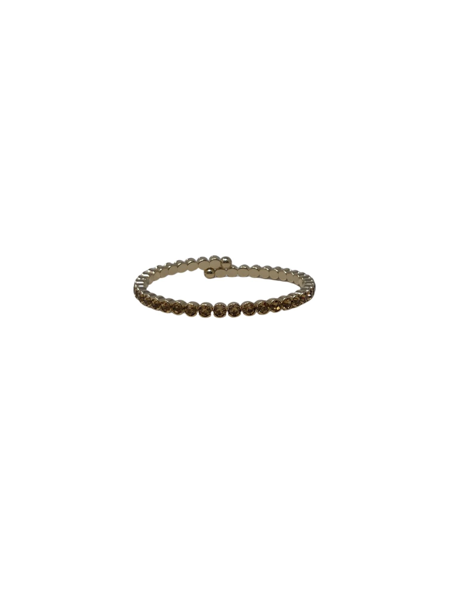 Gold-tone crystal cuff ring featuring a wrap-around design with amber-colored round crystals.