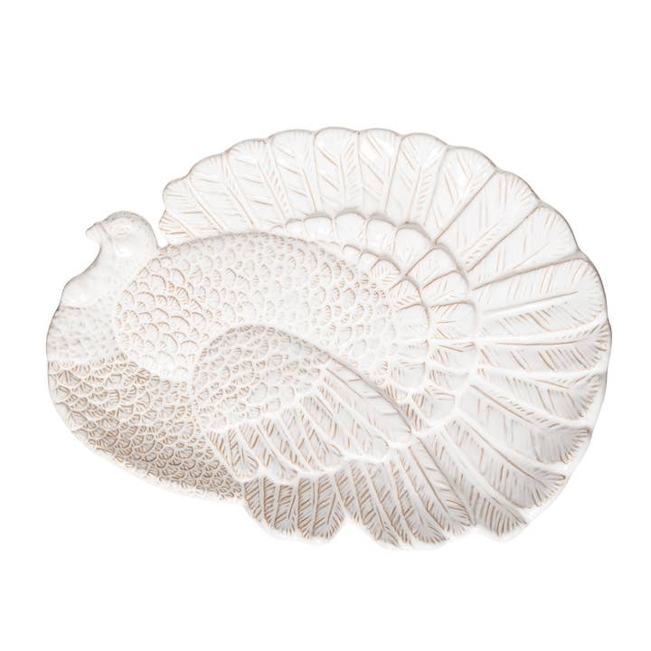 White stoneware Thanksgiving serving platter with an embossed turkey design and textured feathers.