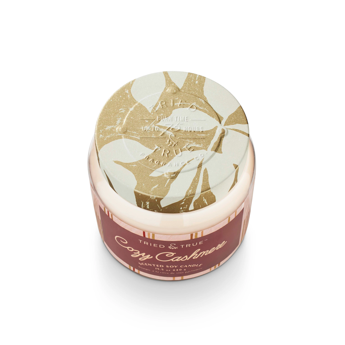 Tried & True Cozy Cashmere scented soy candle in a glass jar with a decorative lid and label.