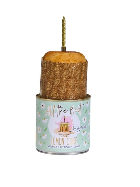 Lemon Cancake in a decorative tin with a gold candle on top.