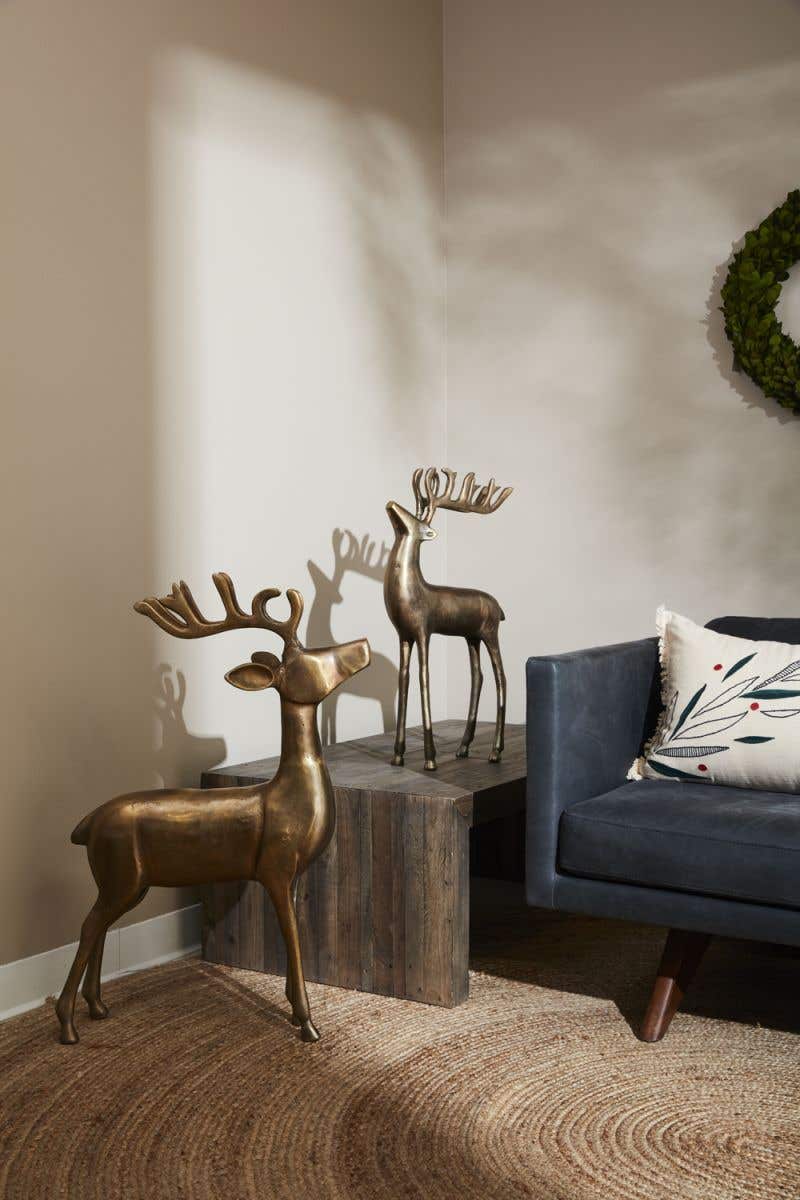 Metal reindeer figurine with a natural silver finish standing in profile.