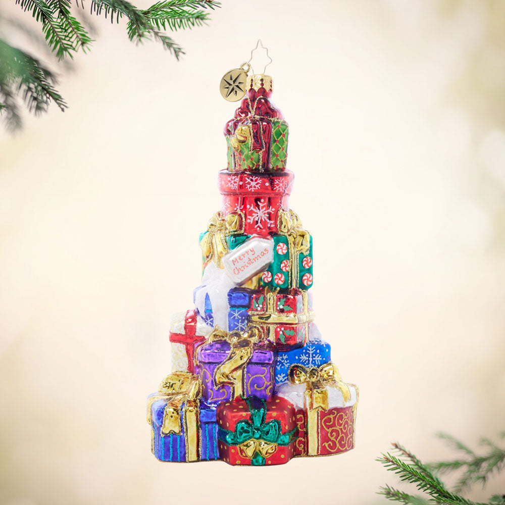 Stacked with Holiday Love glass ornament featuring a colorful pile of wrapped Christmas gifts.