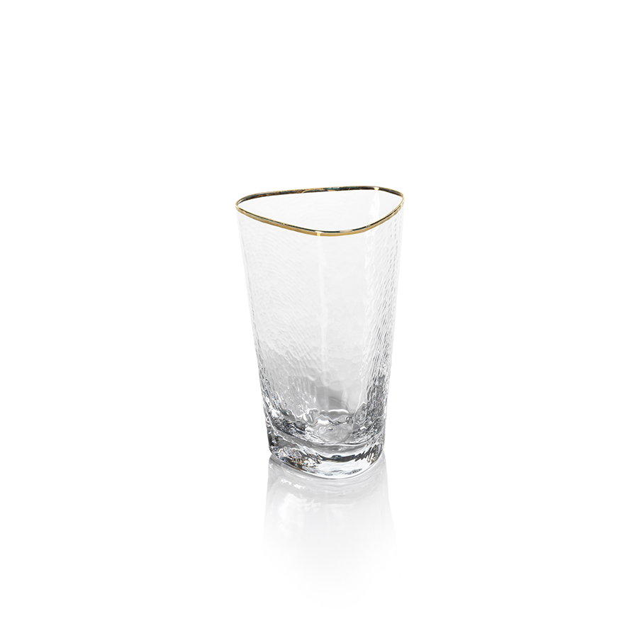 Clear triangular highball glass with a gold rim holding aperitivo