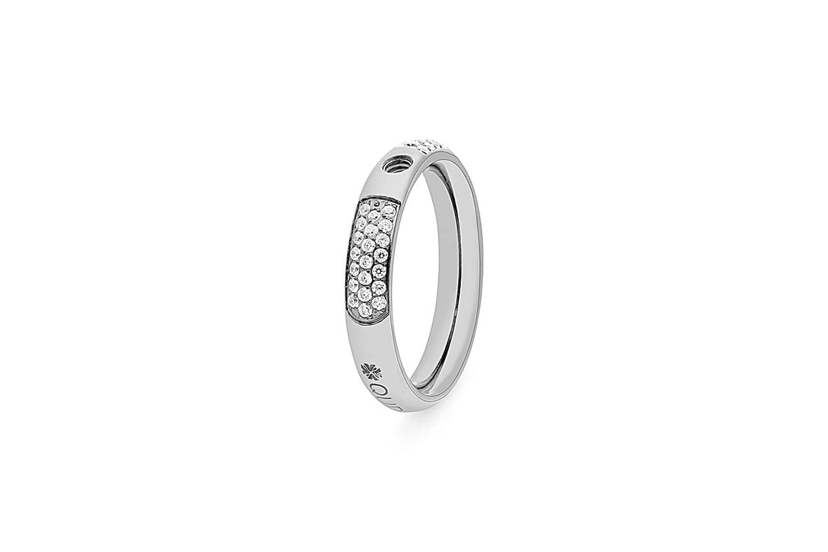Silver ring with a band of small clear stones and engraved details.