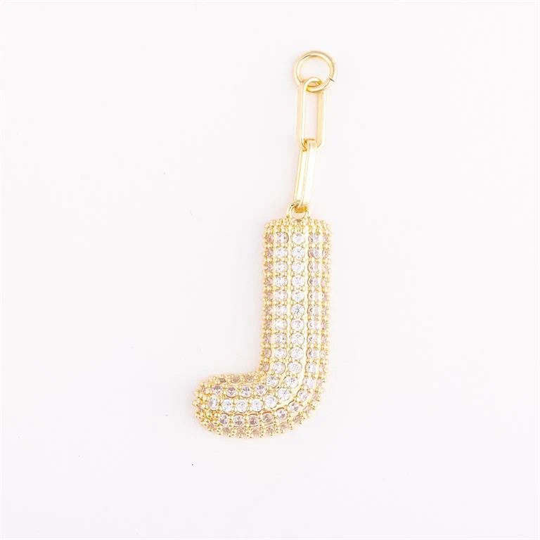 Heather-colored charm bag with gold plating, pave crystal accents, initial letter option, and one-inch extender.