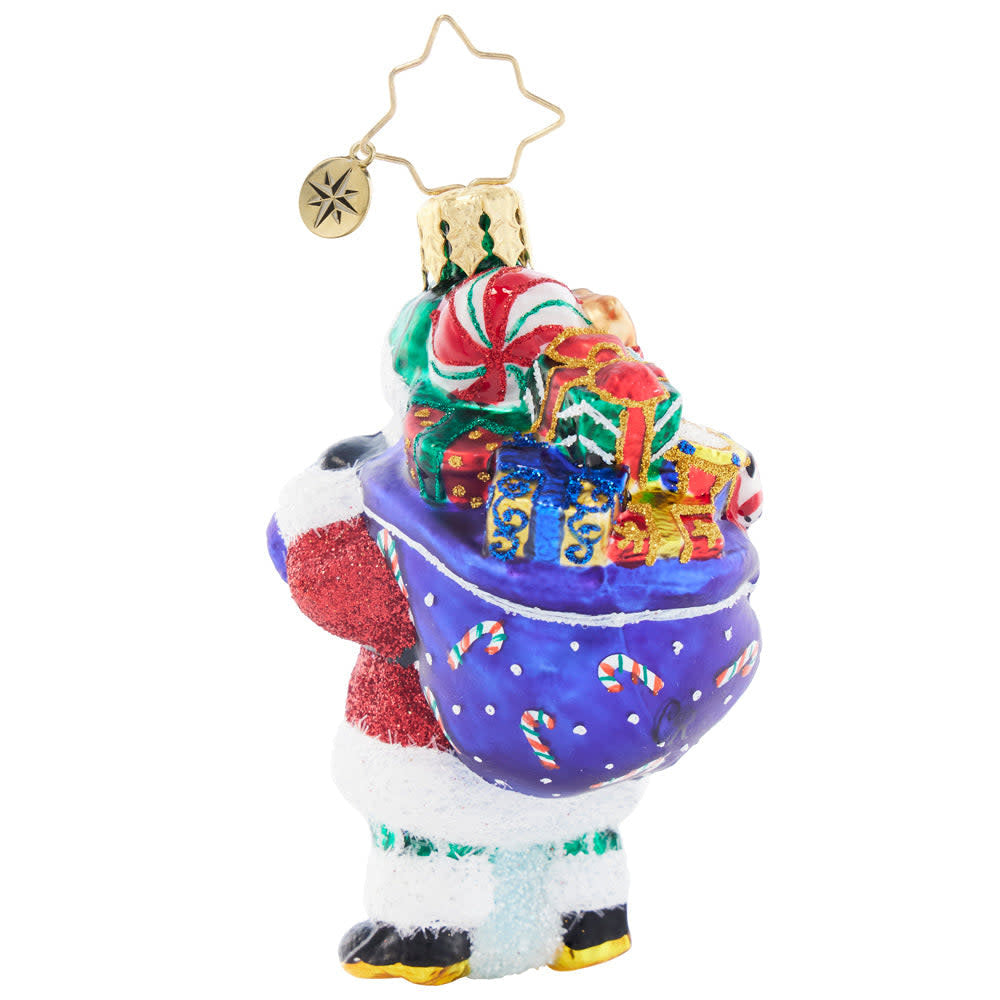 Back view of a Santa figurine holding a festive sack with a golden pocket watch on its chest.