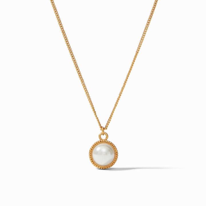 Fleur-De-Lis Solitaire Necklace featuring a round mother of pearl pendant on a gold chain.