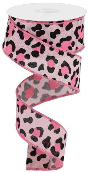 A spool of pale pink leopard print polyester ribbon with black spots.