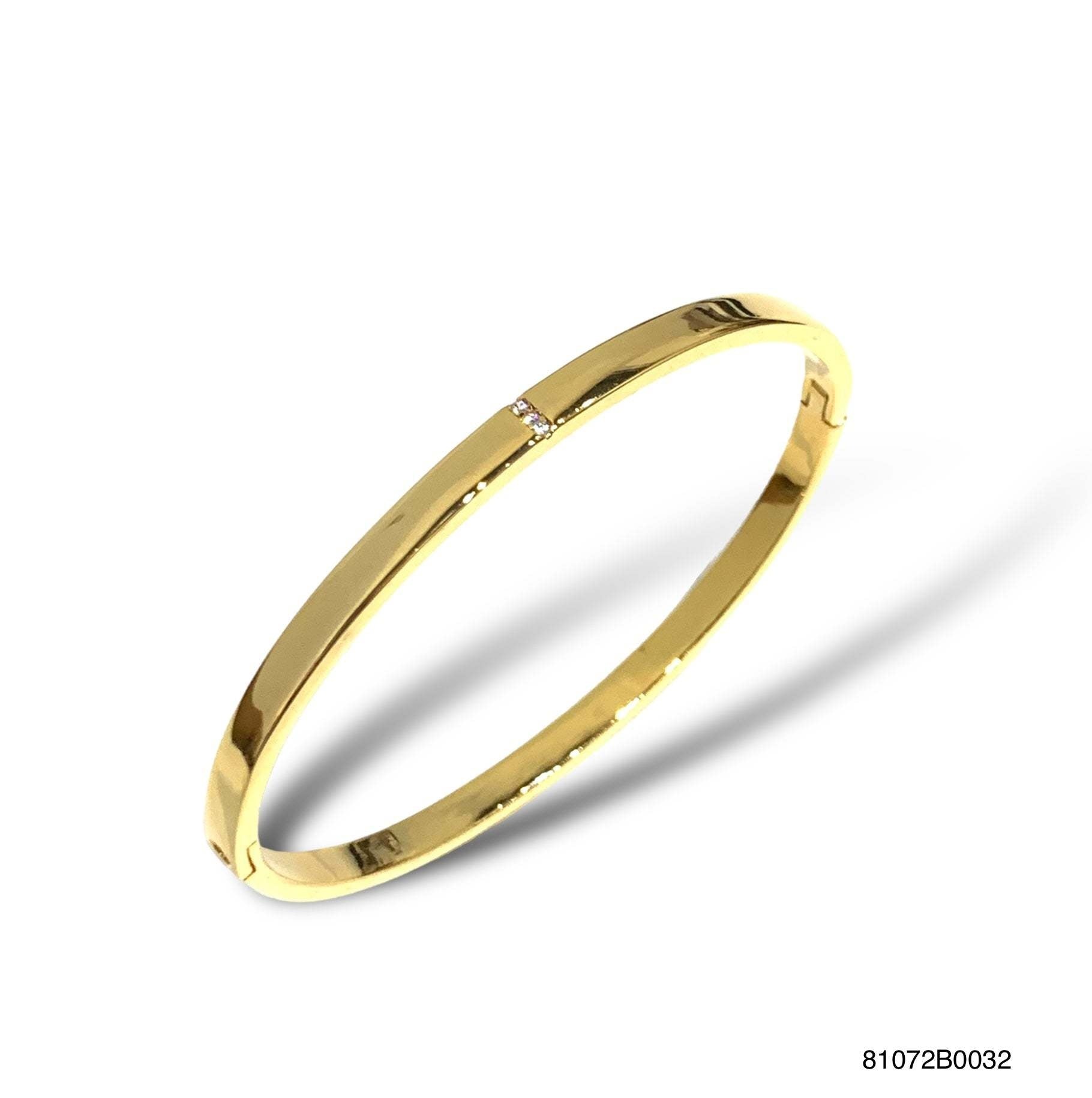 Gold Paloma bangle featuring a vertical cubic zirconia accent with tension closure.