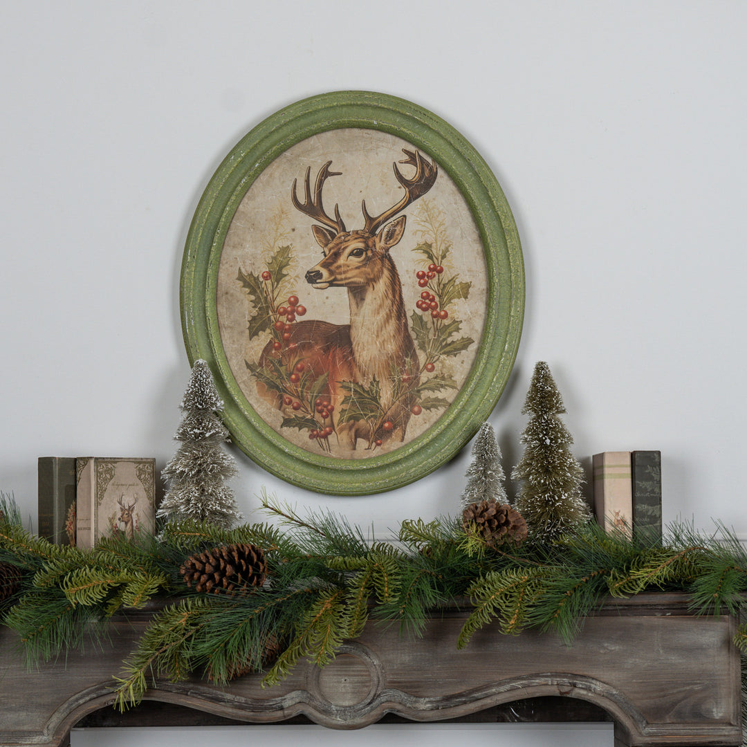 Oval framed print on glass featuring a holiday stag silhouette with natural wood frame.