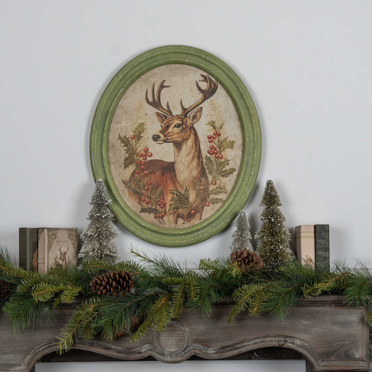 Oval framed print on glass featuring a holiday stag silhouette with natural wood frame.
