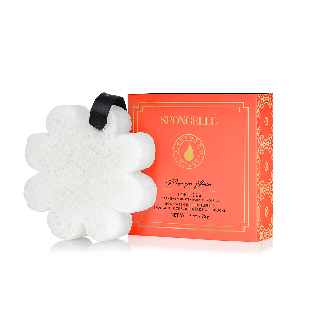 A white bath sponge with a hanging ribbon handle.