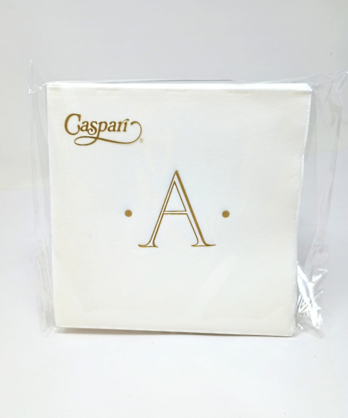 White paper cocktail napkin with an initial letter monogram printed in a subtle tone.