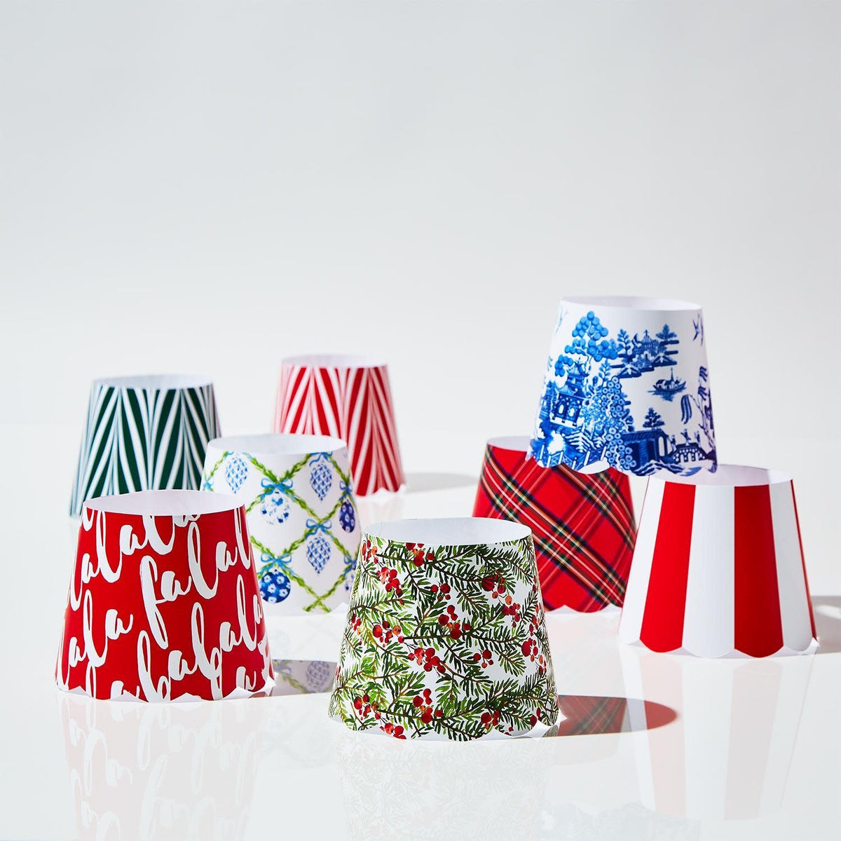 Set of eight paper shade covers with scalloped edges in various holiday patterns.