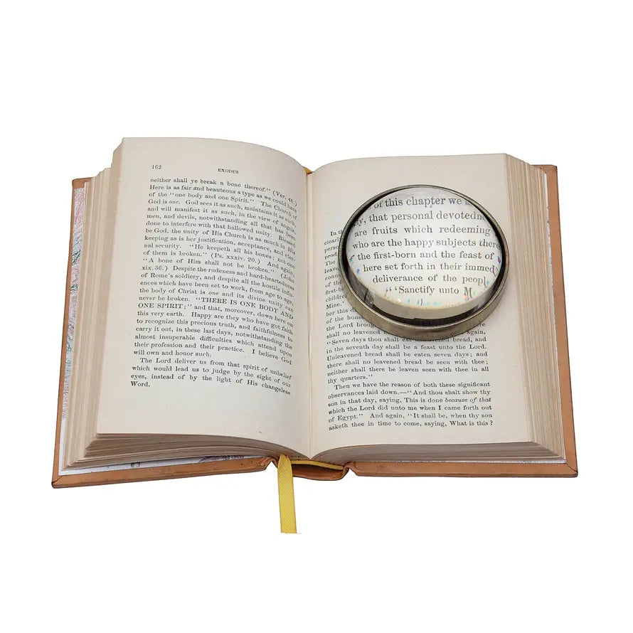 Glass paperweight with magnifying glass top in clear finish