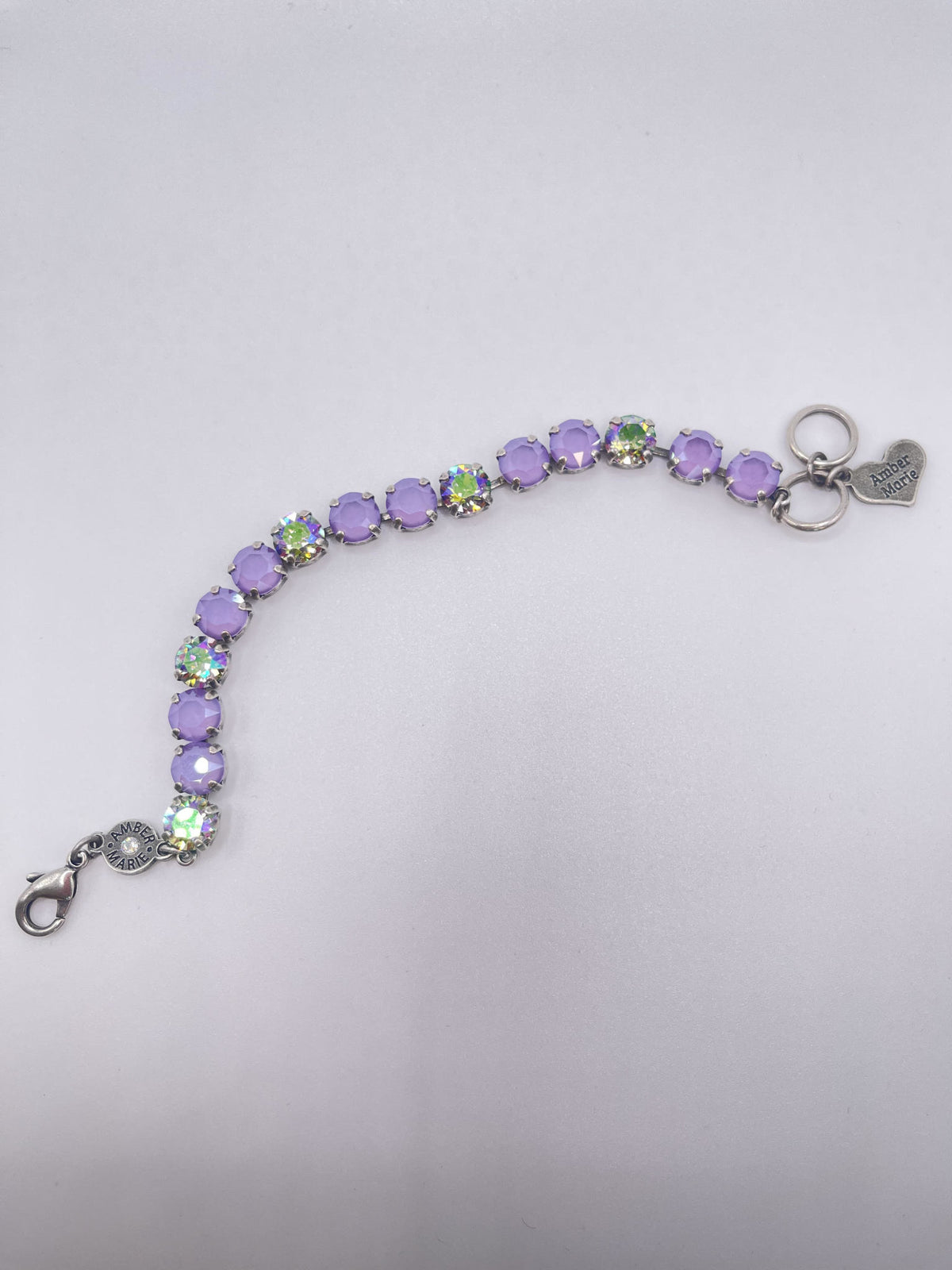 Classic Paris bracelet featuring lavender, lilac, white, and light green stones with an amber tag heart charm.