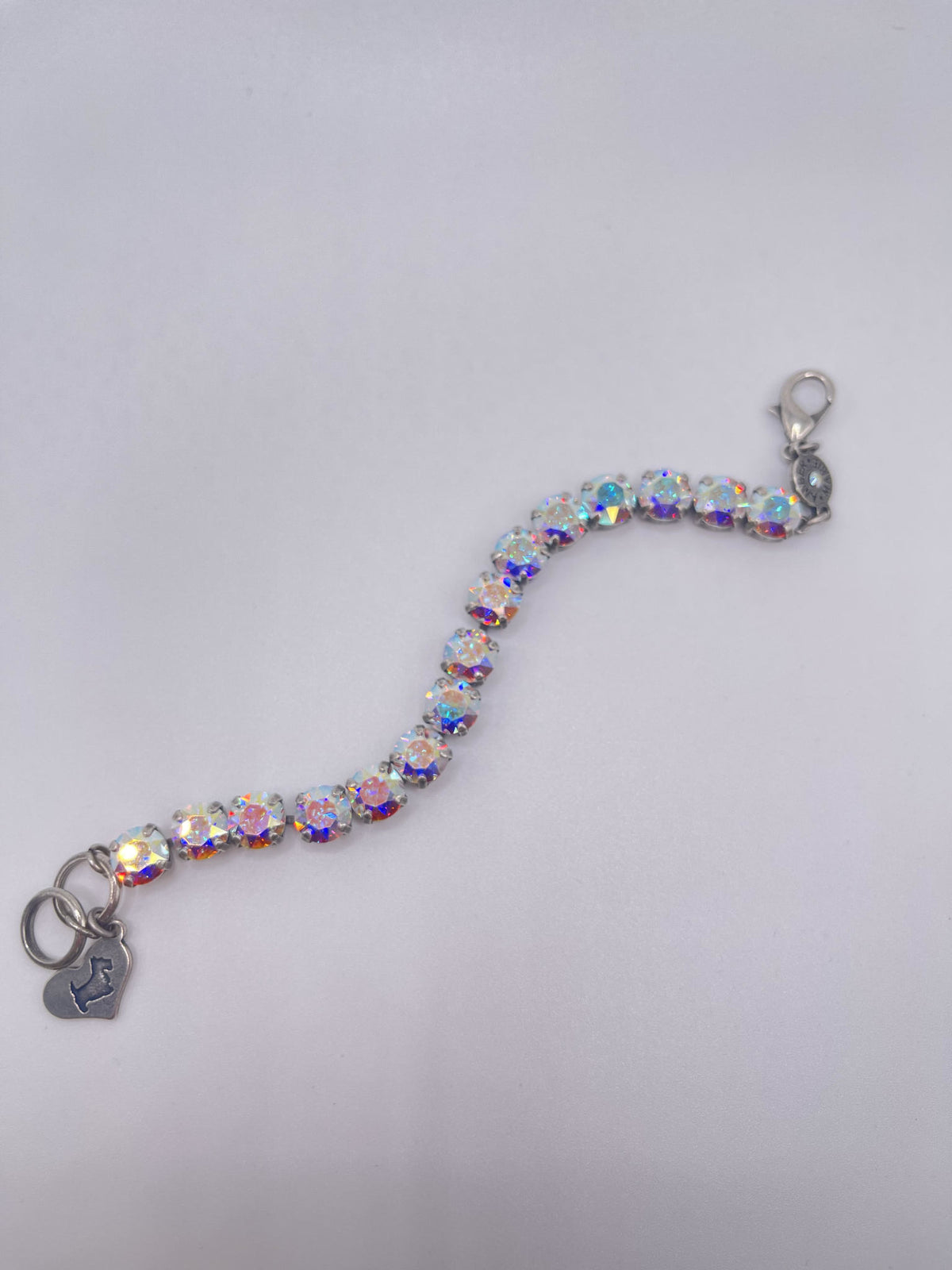 Classic Paris bracelet featuring lavender, lilac, white, and light green stones with an amber tag heart charm.