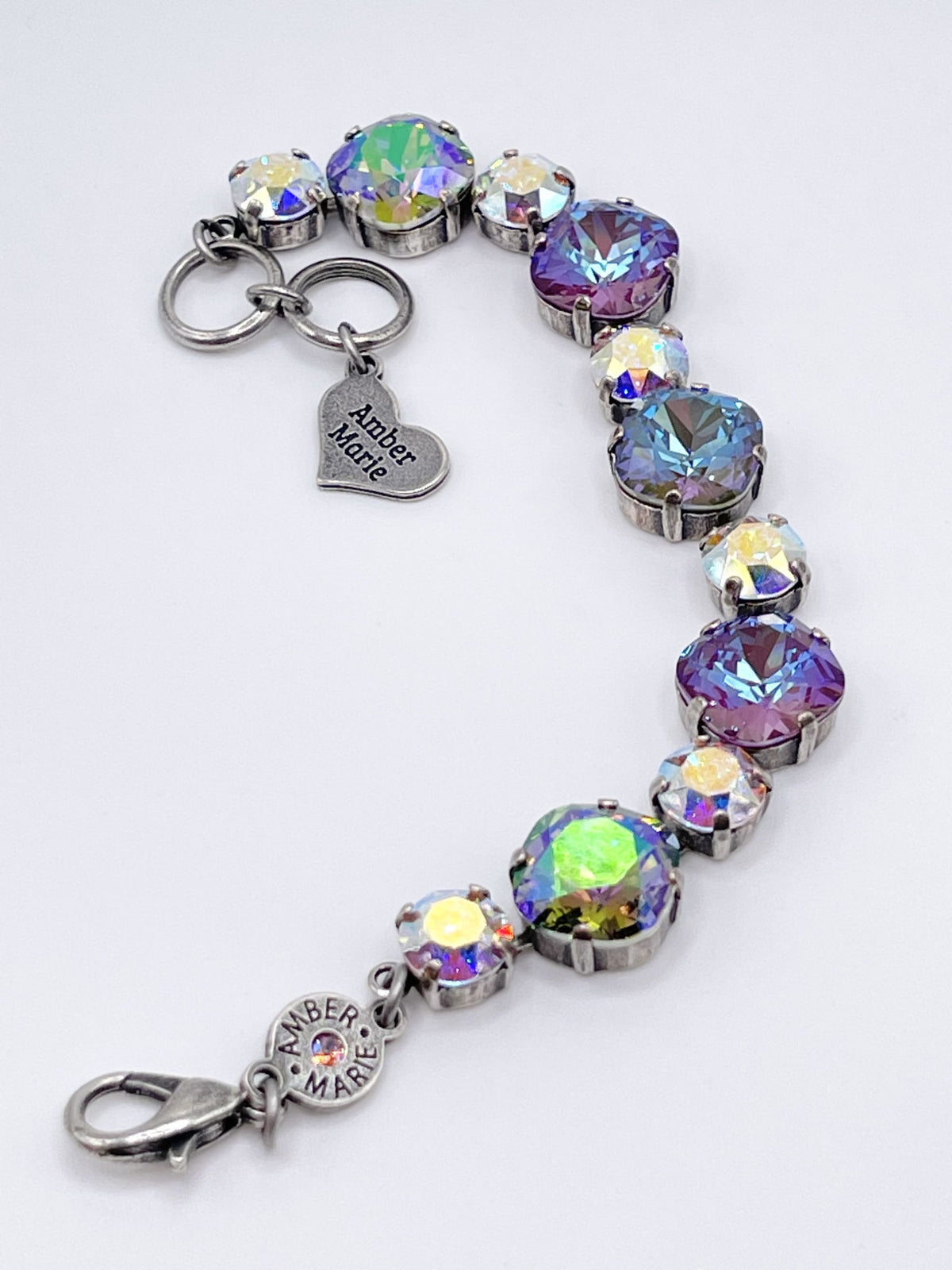 Bracelet with iridescent crystals in silver settings and an Amber Marie heart charm.