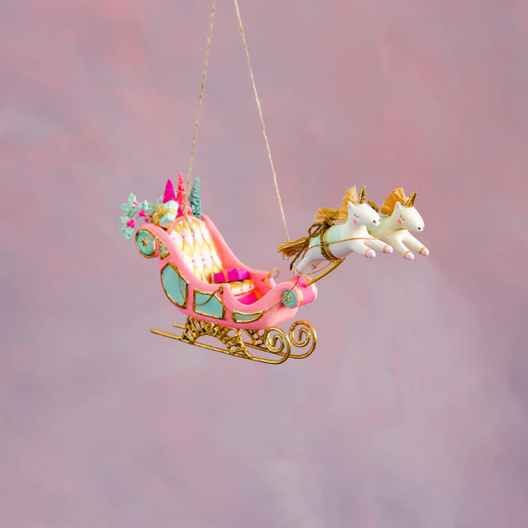Hand-painted gold leaf Parisian sleigh ornament with intricate detailing.