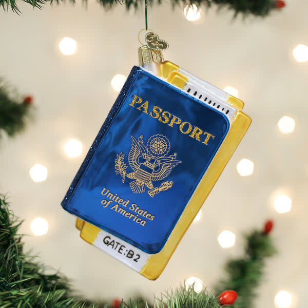 Small passport-shaped ornament with a textured surface resembling leather in earthy tones.