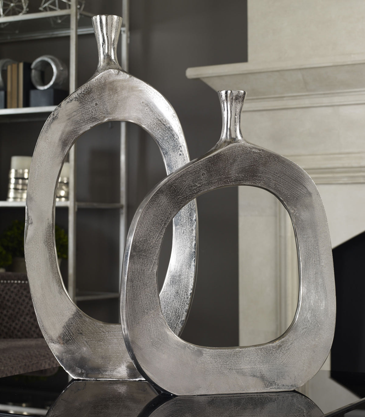 Two Cierra aluminum vases with a matte finish in neutral tones.