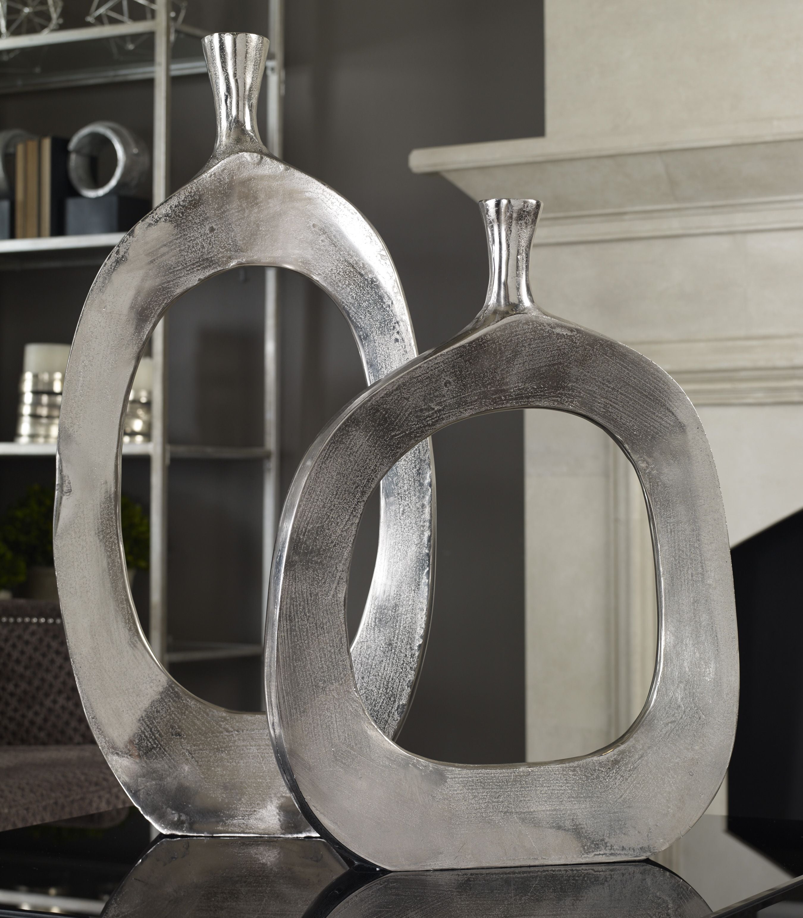 Two Cierra aluminum vases with a matte finish in neutral tones.