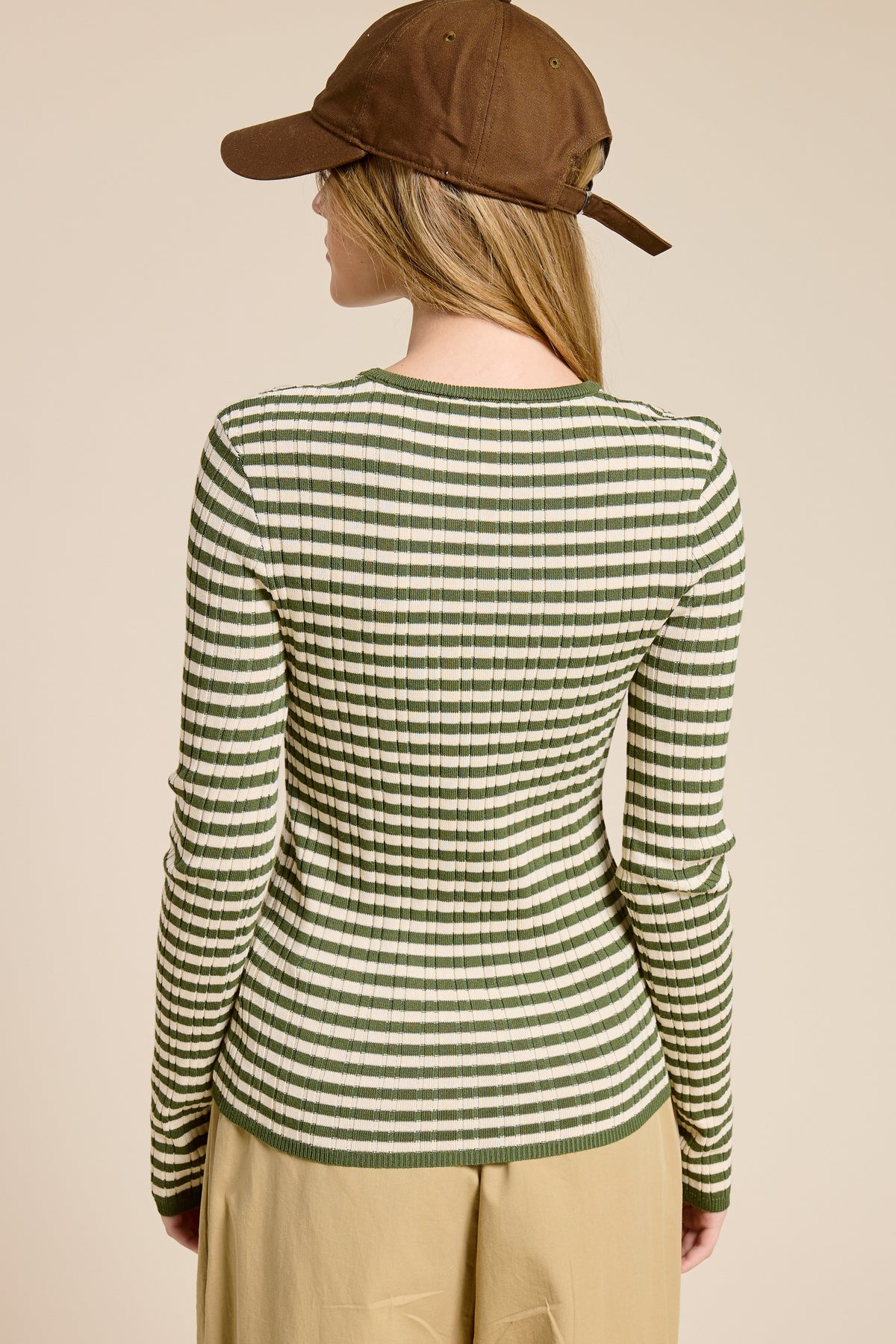Long-sleeve ribbed knit top with horizontal stripes in warm neutrals featuring a crew neckline and snug fit.