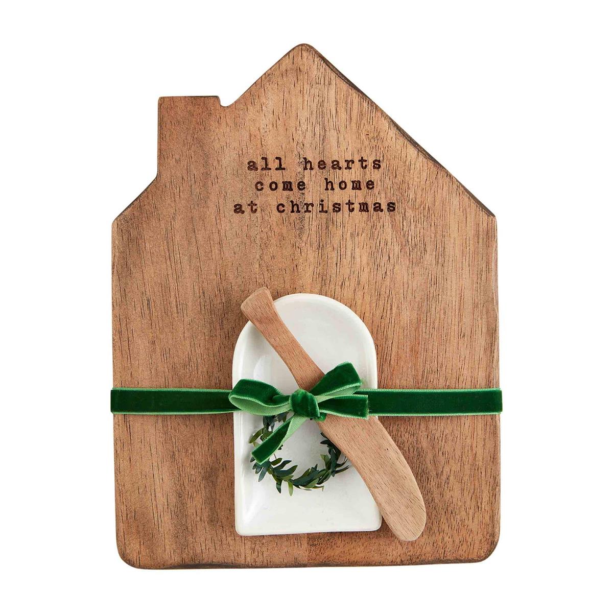 Pine wood serving board with heart-shaped cutouts holding a dip bowl and spreader.