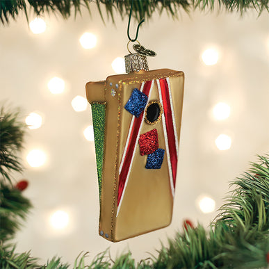 Gold cornhole board Christmas ornament with red stripes and glittery bean bags on a tree.