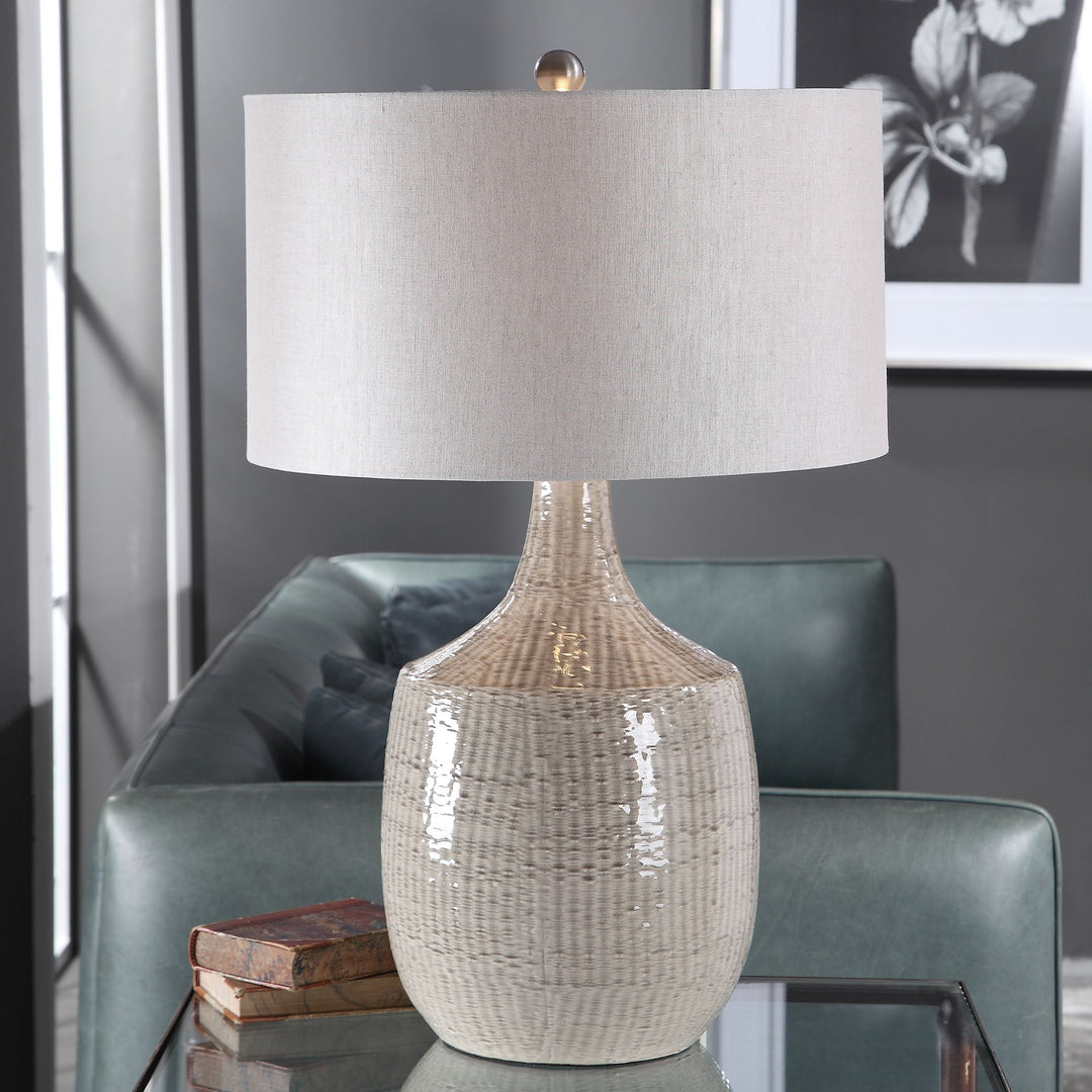 Gray linen hardback drum table lamp with a cylindrical shade measuring 19 inches in diameter.