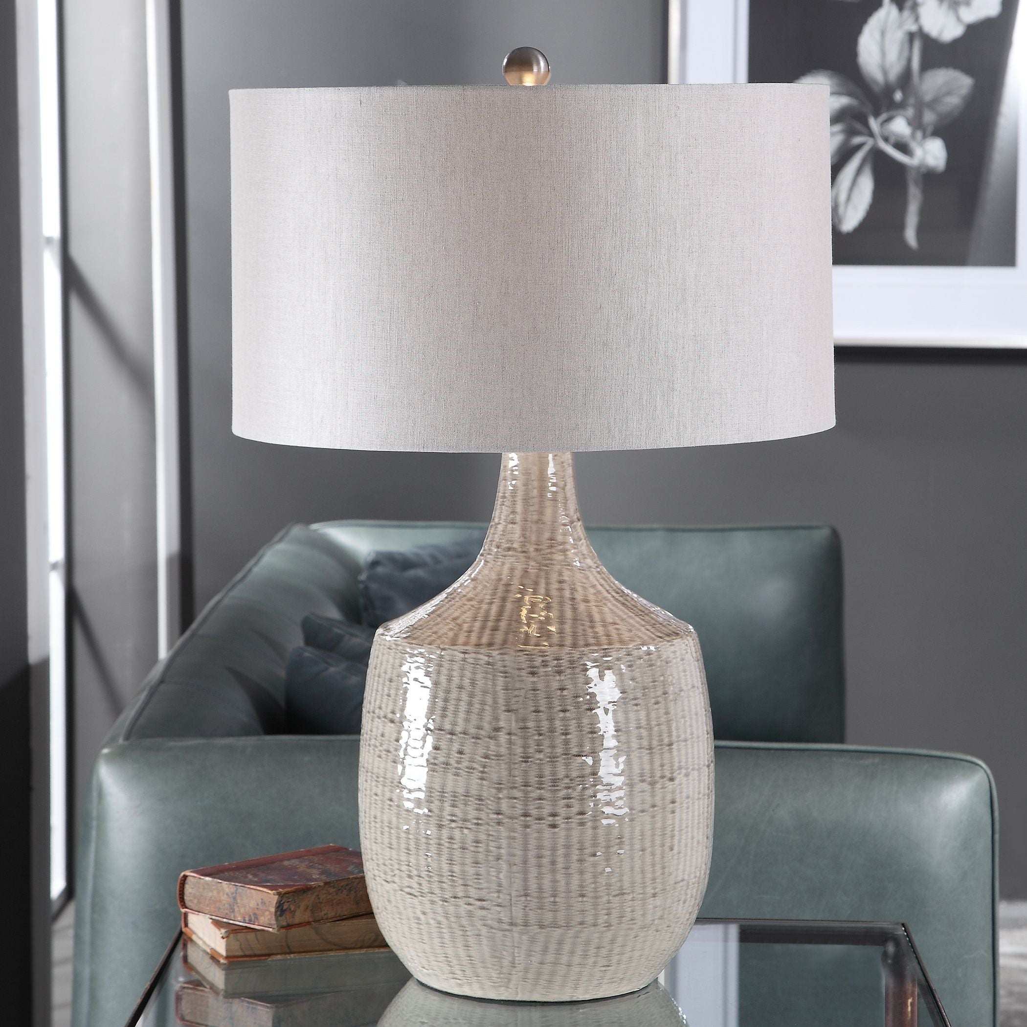 Gray linen hardback drum table lamp with a cylindrical shade measuring 19 inches in diameter.
