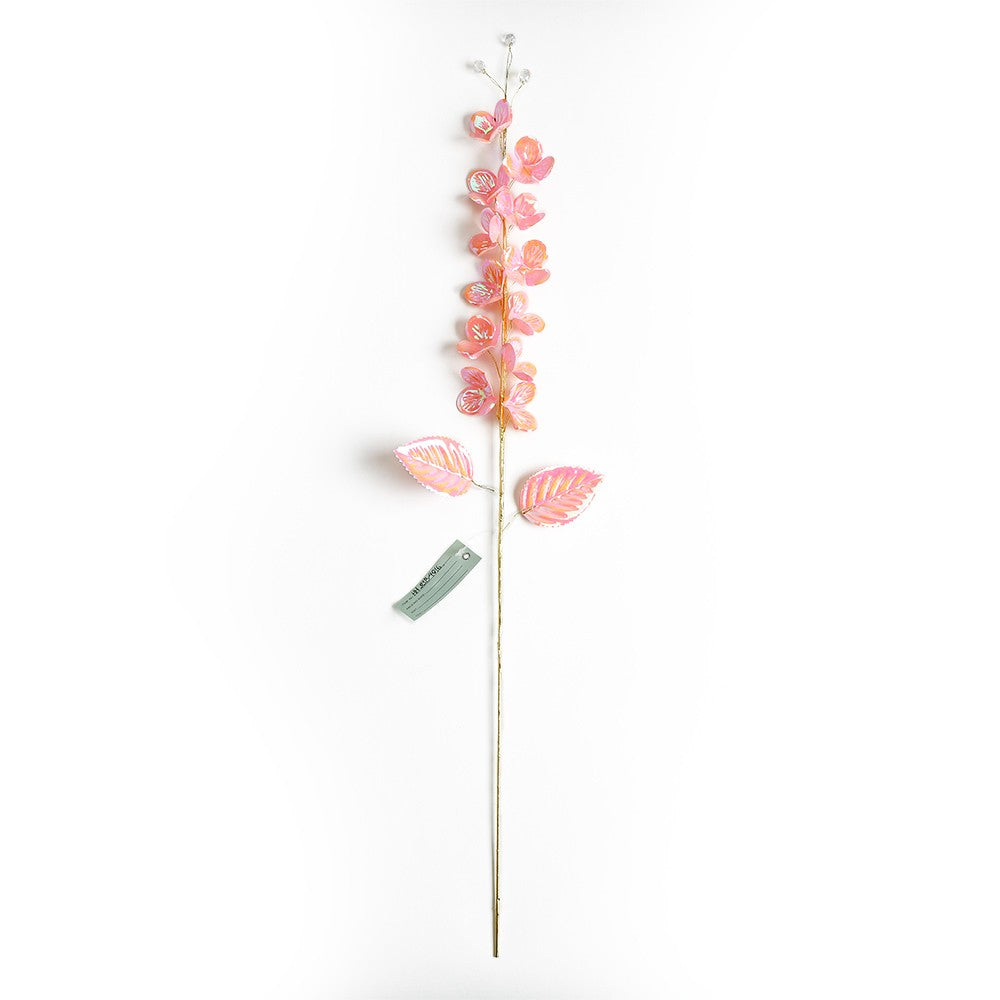 Tall floral stem decoration with red roses and greenery in a clear vase.