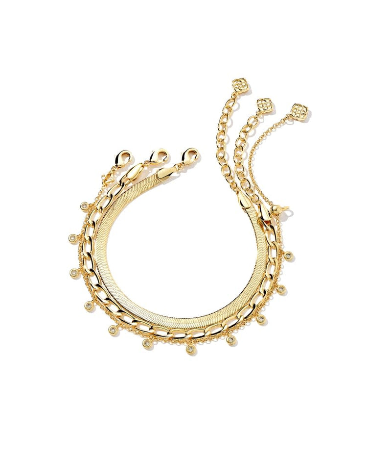 Kassie set of three 14k yellow gold over brass chain bracelets with lobster clasp closures.
