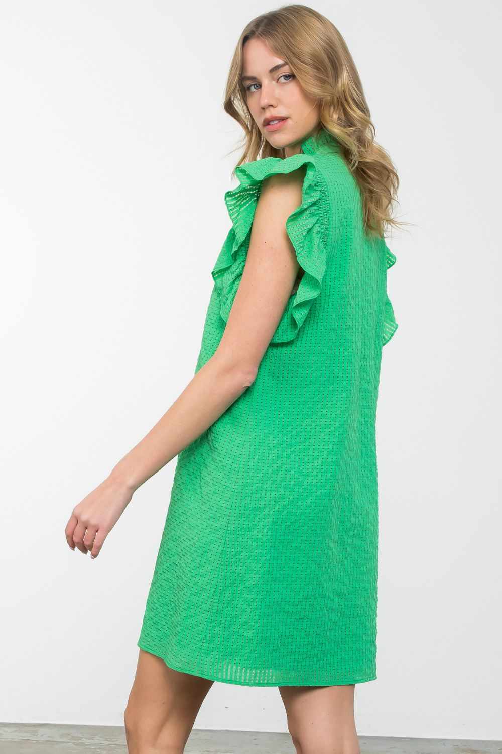 Isabella dress in woven polyester with ruffle sleeves and textured fabric.