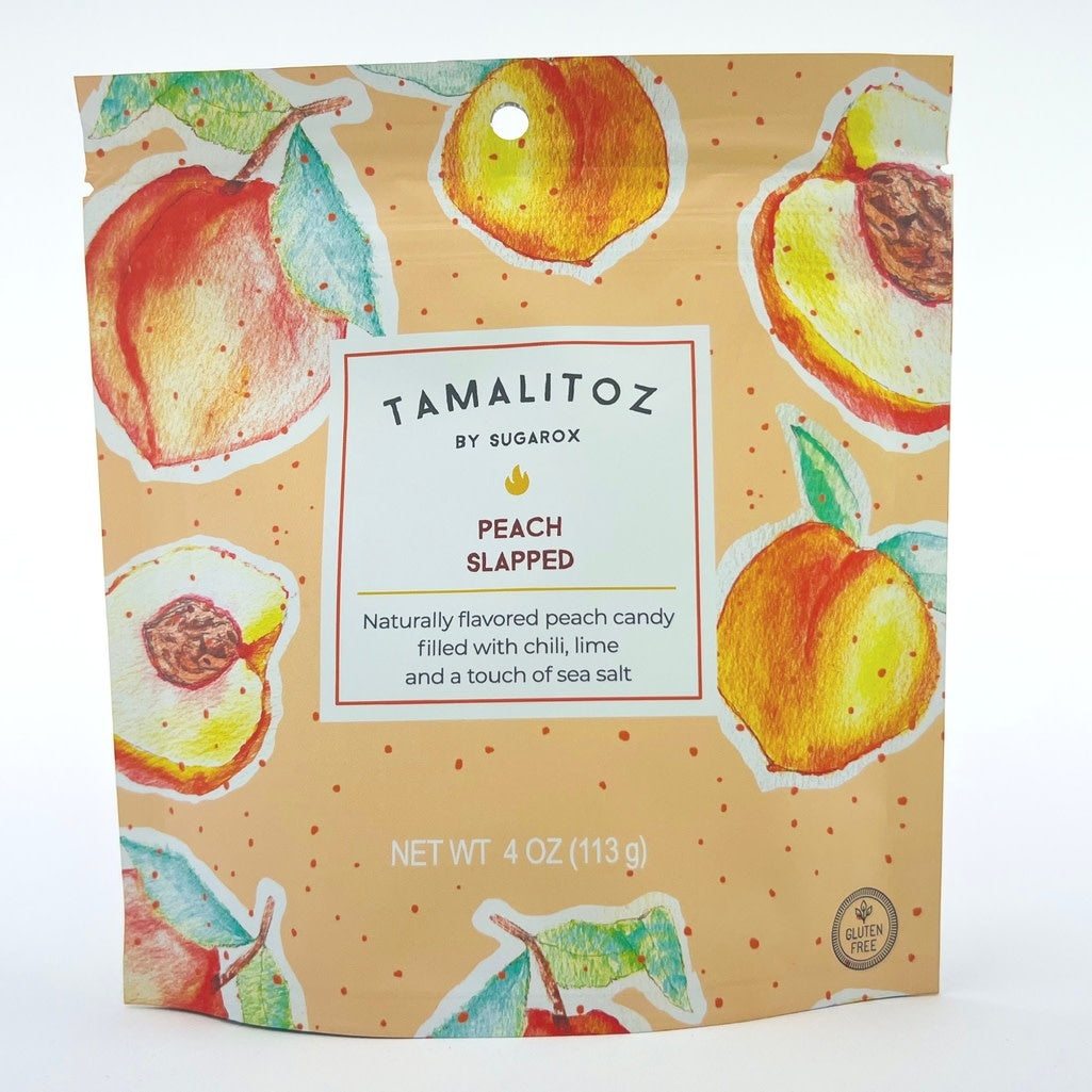 Front view of peach-colored ribbon-style Tamalitoz candy filled with mild chili powder and lime.