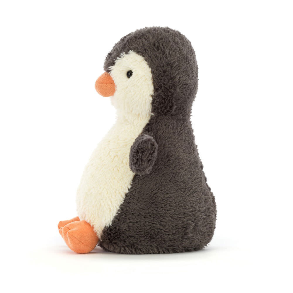 Side view of a medium Peanut Penguin plush toy with vintage-inspired beige polyester fur, sitting silhouette, and friendly face.