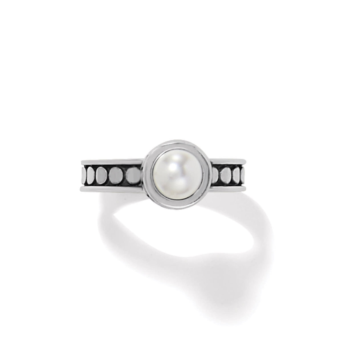 Silver-plated ring with a quarter-inch wide glass pearl cabochon set in Balinese-style pebble dot design.