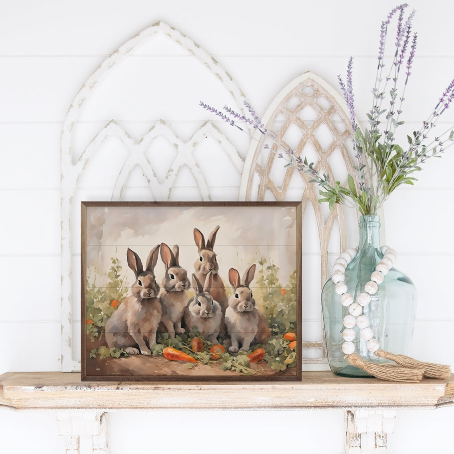 Hand-painted wooden wall art titled Five Bunnies in Carrot Field featuring five bunny faces on American hardwood with a natural walnut frame.
